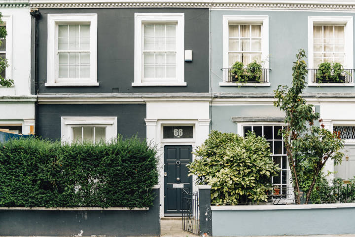 Photo showing the font of 2 houses. A dark grey house shoes the street number 66 and a light grey house shows the number 64