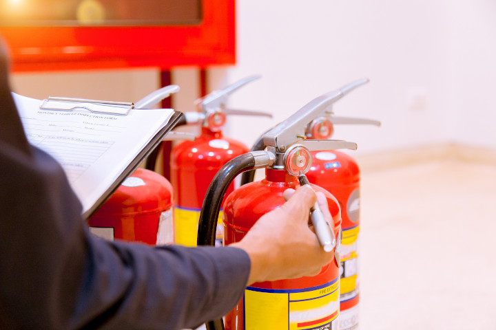 Engineer checking fire extinguisher