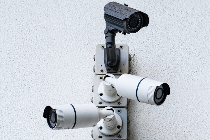 security cameras on white building side