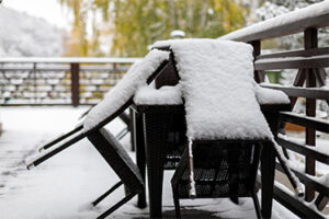 Freshly fallen snow on the furniture of the cafe's summer terrace closing of the summer season