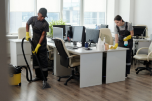 Man & woman cleaning an office space.