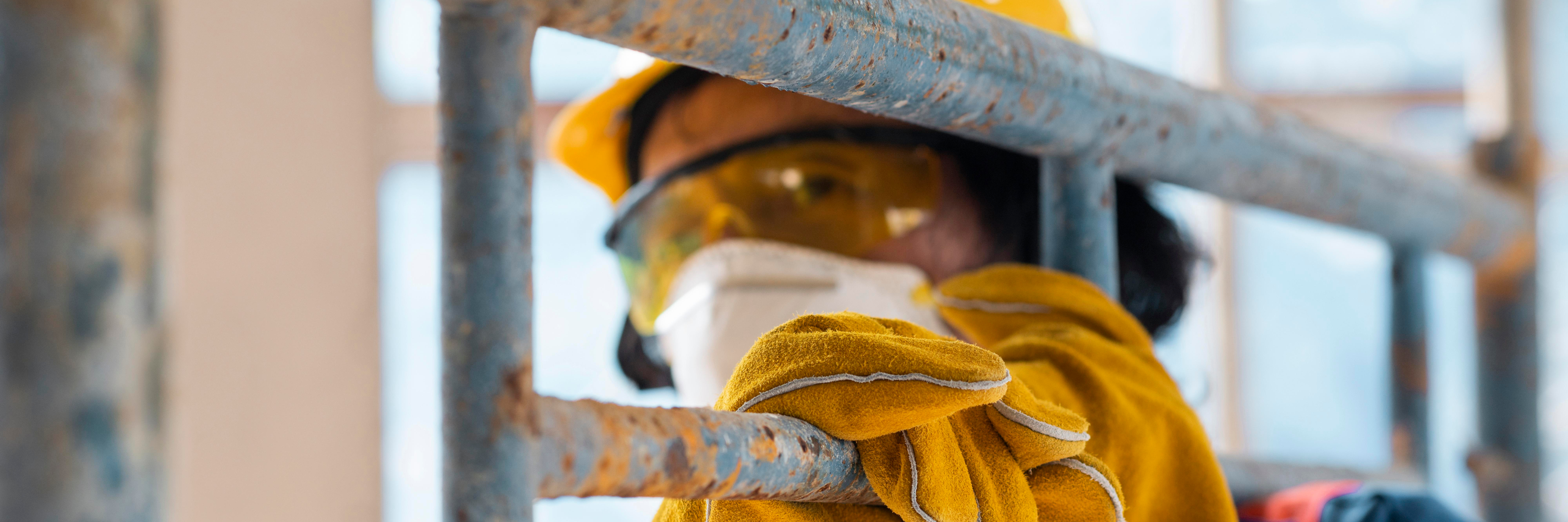 Man with safety equipment checking for asbestos