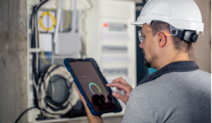 Workman in hard hat with smart meter